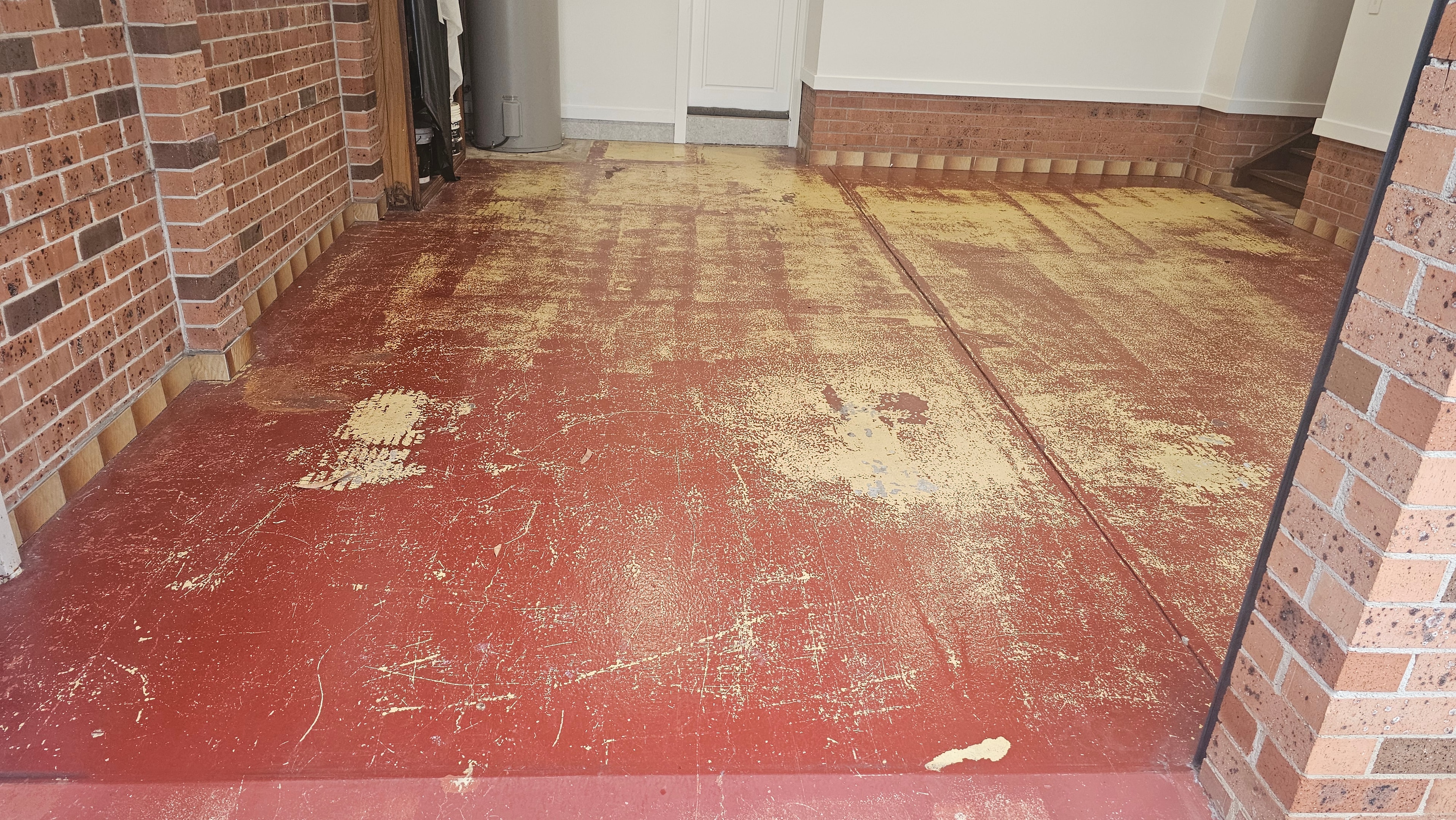 Worn red painted concrete floor before grinding
